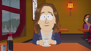 Movie still from “South Park: Joining the Panderverse” (2023), directed by Trey Parker – An animated woman sitting at a table holding a coffee cup; Medium shot, Over the shoulder angle