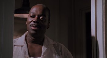 Movie still from “Space Jam” (1996), directed by Joe Pytka – A man in a white shirt is looking at the camera; Close Up shot, Low angle