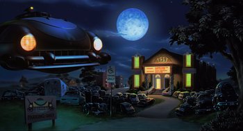 Movie still from “Space Jam” (1996), directed by Joe Pytka – An image of a night scene with cars parked in front of a building; Extreme Wide shot, Low angle