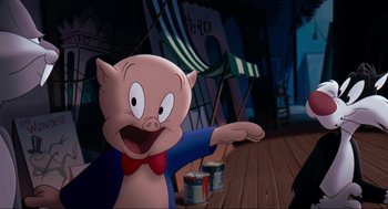 Movie still from “Space Jam” (1996), directed by Joe Pytka – A cartoon pig with a red bow tie and blue shirt; Medium shot, High angle