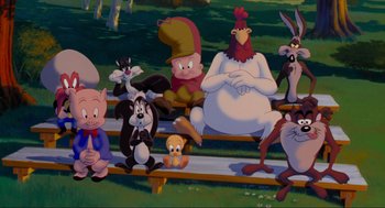 Movie still from “Space Jam” (1996), directed by Joe Pytka – A group of cartoon characters sitting on top of a bench; Wide shot, High angle