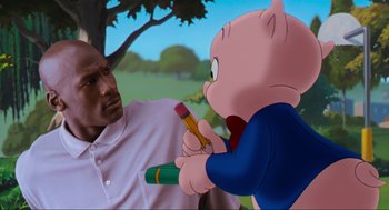 Movie still from “Space Jam” (1996), directed by Joe Pytka – A man holding a pencil and a pencil in front of a cartoon pig; Close Up shot, Over the shoulder angle