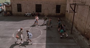 Movie still from “Space Jam” (1996), directed by Joe Pytka – A group of young people playing basketball on a court; Extreme Wide shot, High angle
