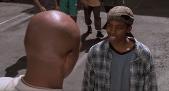Movie still from “Space Jam” (1996), directed by Joe Pytka – Two young men talking to each other on the street; Close Up shot, High angle