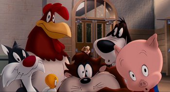 Movie still from “Space Jam” (1996), directed by Joe Pytka – A group of cartoon characters sitting next to each other in front of a door; Wide shot, High angle