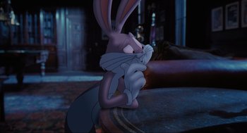 Movie still from “Space Jam” (1996), directed by Joe Pytka – A rabbit sitting on top of a wooden table next to a wall; Close Up shot, High angle