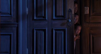 Movie still from “Space Jam” (1996), directed by Joe Pytka – Two children peeking out of a dark door; Medium shot, High angle
