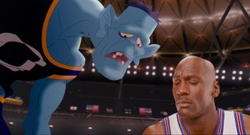 Movie still from “Space Jam” (1996), directed by Joe Pytka – An image of an animated character and an animated character in a basketball game; Medium shot, Over the shoulder angle