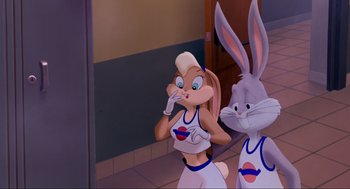 Movie still from “Space Jam” (1996), directed by Joe Pytka – Two cartoon characters are standing next to each other; Medium shot, Over the shoulder angle