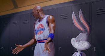 Movie still from “Space Jam” (1996), directed by Joe Pytka – A basketball player and a rabbit in front of lockers; Medium shot, Over the shoulder angle