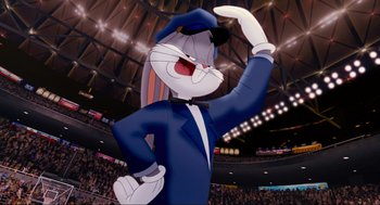 Movie still from “Space Jam” (1996), directed by Joe Pytka – A cartoon rabbit wearing a blue suit and hat; Wide shot, Low angle