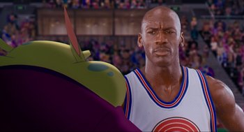 Movie still from “Space Jam” (1996), directed by Joe Pytka – A cartoon character and a basketball player; Close Up shot, Over the shoulder angle