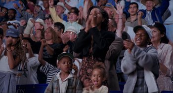 Movie still from “Space Jam” (1996), directed by Joe Pytka – A crowd of people in the stands clapping; Medium shot, Low angle