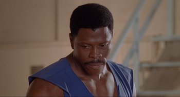 Movie still from “Space Jam” (1996), directed by Joe Pytka – A person wearing a blue shirt; Close Up shot, Low angle