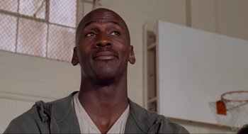 Movie still from “Space Jam” (1996), directed by Joe Pytka – A person looking up at the sky; Close Up shot, Low angle