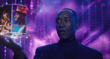 Movie still from “Space Jam: A New Legacy” (2021), directed by Malcolm D. Lee – A man in a black suit is standing in front of purple lights; Close Up shot, Low angle