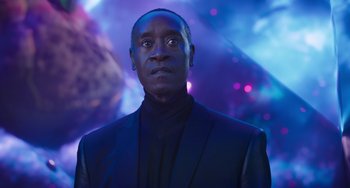 Movie still from “Space Jam: A New Legacy” (2021), directed by Malcolm D. Lee – A man wearing a suit and tie in front of a purple background; Close Up shot, Low angle