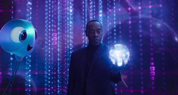 Movie still from “Space Jam: A New Legacy” (2021), directed by Malcolm D. Lee – A man in a suit holding a glowing ball of light; Medium shot, Low angle