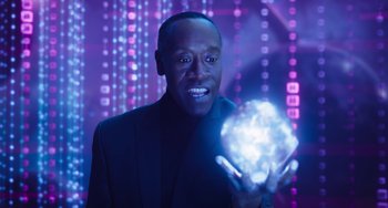 Movie still from “Space Jam: A New Legacy” (2021), directed by Malcolm D. Lee – A man in a black suit holding a glowing object; Close Up shot, Low angle