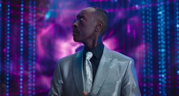 Movie still from “Space Jam: A New Legacy” (2021), directed by Malcolm D. Lee – A man in a silver suit and a tie; Close Up shot, Low angle