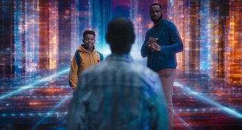 Movie still from “Space Jam: A New Legacy” (2021), directed by Malcolm D. Lee – A couple of men standing next to each other in a room; Wide shot, Over the shoulder angle