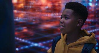 Movie still from “Space Jam: A New Legacy” (2021), directed by Malcolm D. Lee – A young man in a yellow jacket looking up at the sky; Close Up shot, Over the shoulder angle