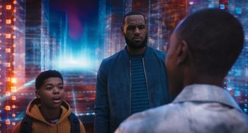 Movie still from “Space Jam: A New Legacy” (2021), directed by Malcolm D. Lee – A man standing next to two other men; Medium shot, Over the shoulder angle