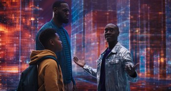 Movie still from “Space Jam: A New Legacy” (2021), directed by Malcolm D. Lee – Two men and a boy are standing in front of a wall; Medium shot, Over the shoulder angle