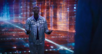 Movie still from “Space Jam: A New Legacy” (2021), directed by Malcolm D. Lee – A man standing in front of an image of a city; Medium shot, Low angle