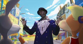 Movie still from “Space Jam: A New Legacy” (2021), directed by Malcolm D. Lee – A man in a blue suit and a white hat; Medium shot, Low angle