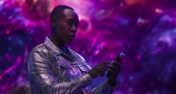 Movie still from “Space Jam: A New Legacy” (2021), directed by Malcolm D. Lee – A man is looking at his cell phone; Medium shot, Low angle