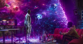 Movie still from “Space Jam: A New Legacy” (2021), directed by Malcolm D. Lee – A man standing in front of a living room with purple lights; Wide shot, Over the shoulder angle