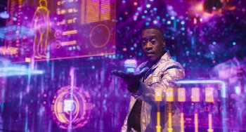 Movie still from “Space Jam: A New Legacy” (2021), directed by Malcolm D. Lee – A man standing in front of a purple background; Medium shot, Over the shoulder angle