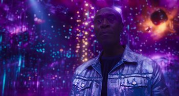 Movie still from “Space Jam: A New Legacy” (2021), directed by Malcolm D. Lee – A man wearing a silver jacket standing in front of lights; Medium shot, Low angle