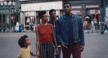 Movie still from “Space Jam: A New Legacy” (2021), directed by Malcolm D. Lee – A group of people standing on the sidewalk; Medium shot, Over the shoulder angle