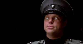 Movie still from “Spaceballs” (1987), directed by Mel Brooks – A man wearing a uniform and a hat; Close Up shot, Low angle