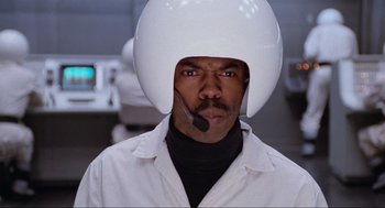 Movie still from “Spaceballs” (1987), directed by Mel Brooks – A man wearing a white helmet and a white lab coat; Close Up shot, Low angle