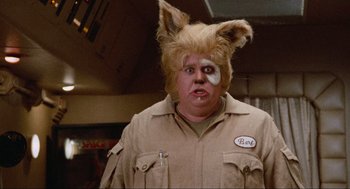 Movie still from “Spaceballs” (1987), directed by Mel Brooks – A man in a costume with a patch on his face; Close Up shot, Over the shoulder angle