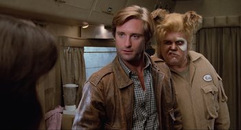 Movie still from “Spaceballs” (1987), directed by Mel Brooks – A man in a brown leather jacket standing next to another man in a brown leather jacket; Close Up shot, Over the shoulder angle