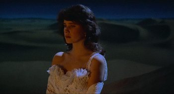 Movie still from “Spaceballs” (1987), directed by Mel Brooks – A woman in a white dress standing in front of a field; Medium shot, Low angle