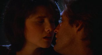 Movie still from “Spaceballs” (1987), directed by Mel Brooks – A man and a woman kissing in the dark; Extreme Close Up shot, Low angle