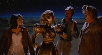 Movie still from “Spaceballs” (1987), directed by Mel Brooks – A man and a woman standing next to each other in front of a desert; Medium shot, High angle