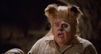 Movie still from “Spaceballs” (1987), directed by Mel Brooks – A man in a bear costume with a white eye patch; Close Up shot, Over the shoulder angle