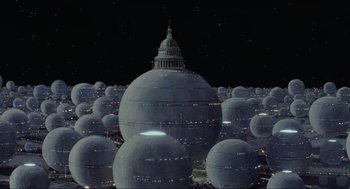 Movie still from “Spaceballs” (1987), directed by Mel Brooks – A large group of domed buildings in the middle of the night; Extreme Wide shot, Low angle