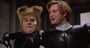 Movie still from “Spaceballs” (1987), directed by Mel Brooks – Two men in black and white outfits one of them has a cat on his head and the other is wearing a black and white suit; Close Up shot, Low angle