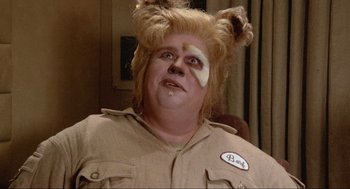 Movie still from “Spaceballs” (1987), directed by Mel Brooks – A man with a blonde wig and a patch on his face; Close Up shot, High angle
