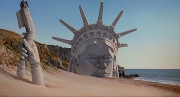 Movie still from “Spaceballs” (1987), directed by Mel Brooks – A statue of liberty head on the beach; Extreme Wide shot, Low angle