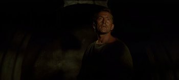 Movie still from “Spartacus” (1960), directed by Stanley Kubrick – A man standing in the dark with his eyes wide open; Medium shot, Low angle