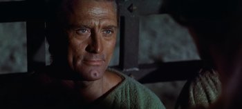 Movie still from “Spartacus” (1960), directed by Stanley Kubrick – A person wearing a green shirt; Close Up shot, Low angle