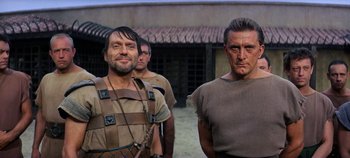 Movie still from “Spartacus” (1960), directed by Stanley Kubrick – A group of men standing next to each other; Medium shot, Low angle